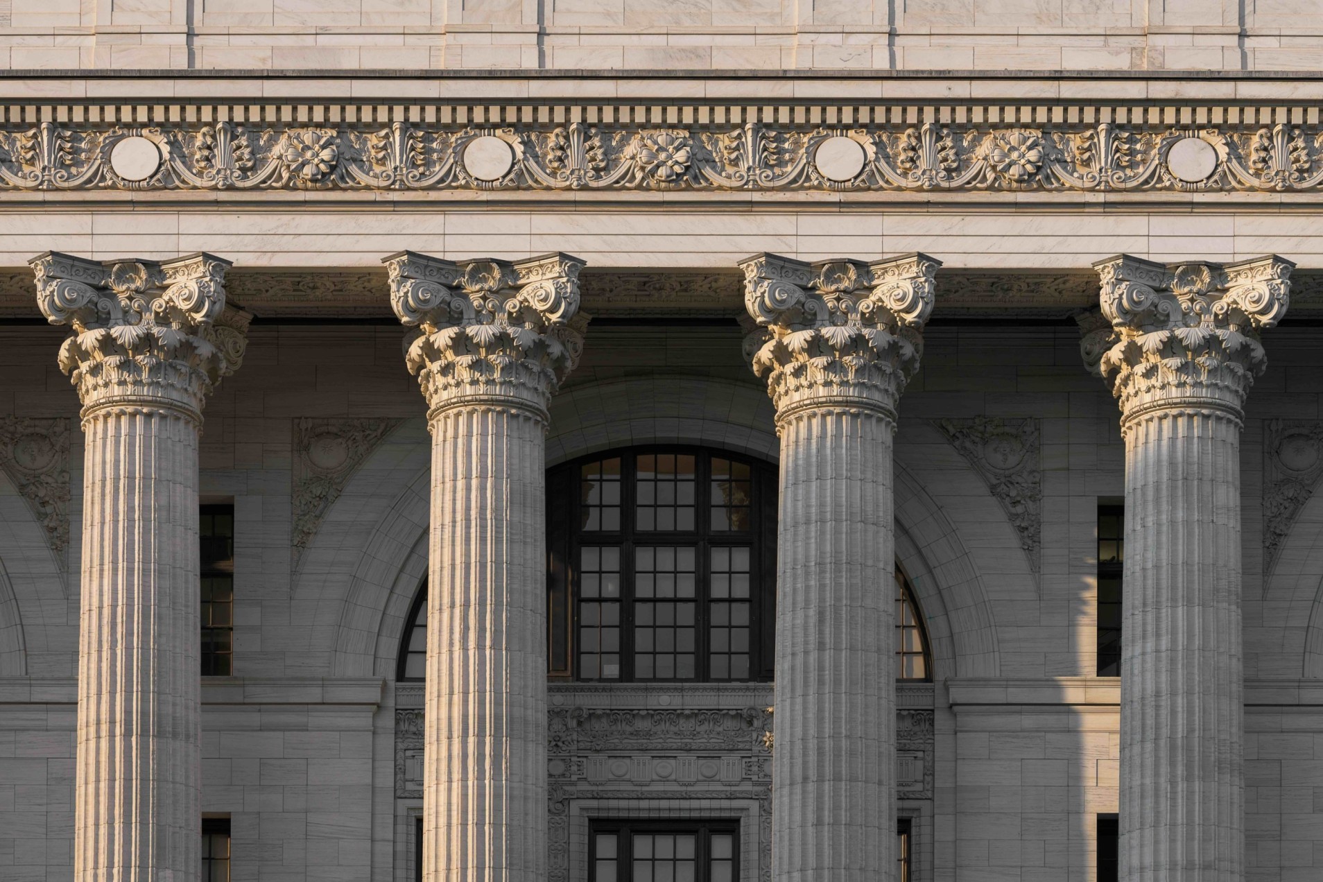 A picture of 4 pillars on the front of a classical building representing the four pillars of TestReach use to maintain test integrity in online examinations.